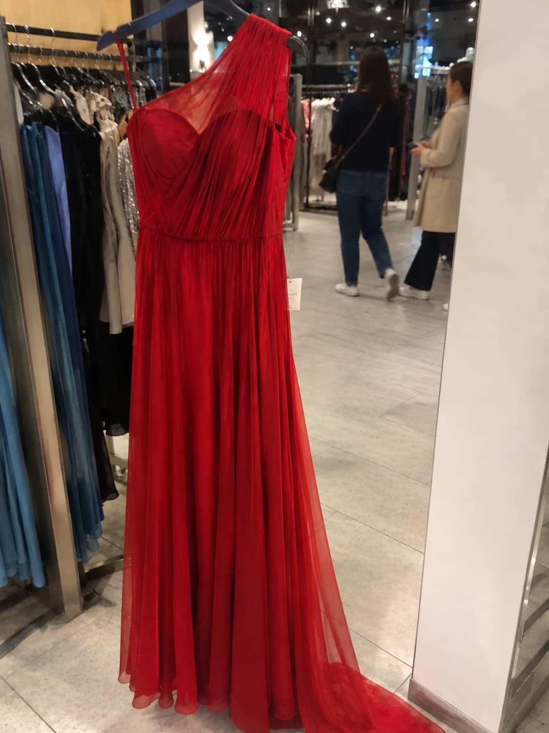 The photo Marra Atelier uploaded: the red dress on a rack in the shop